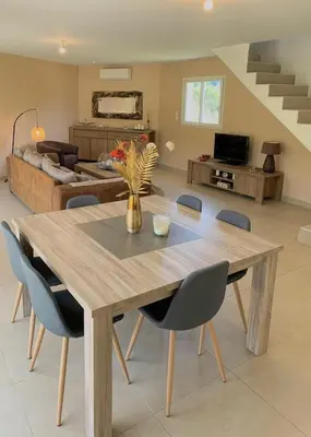 a dining table and chairs in a living room at VILLA PETRETO in Petreto-Bicchisano