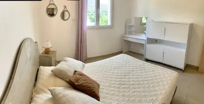 a small bedroom with a bed and a sink at VILLA PETRETO in Petreto-Bicchisano