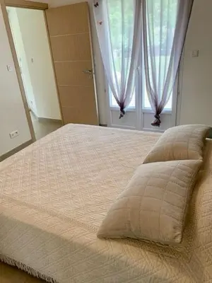 a large bed in a bedroom with a window at VILLA PETRETO in Petreto-Bicchisano