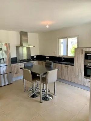 a kitchen with a table and chairs in it at VILLA PETRETO in Petreto-Bicchisano