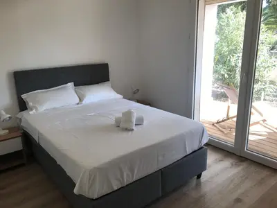 a bedroom with a bed with two towels on it at Résidence Fiori di Cala Rossa in Lecci