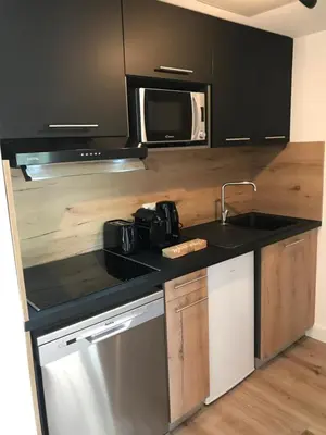 a kitchen with a sink and a microwave at Résidence Fiori di Cala Rossa in Lecci
