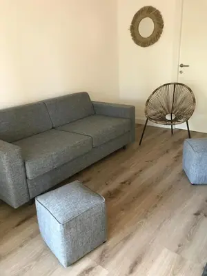 a living room with a couch and a chair at Résidence Fiori di Cala Rossa in Lecci
