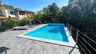 a swimming pool on a deck next to a house at Casa maria in Porto-Vecchio