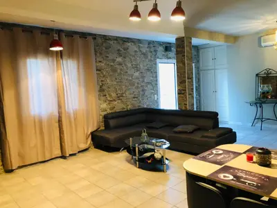 a living room with a couch and a table at Casa maria in Porto-Vecchio