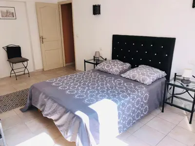 a bedroom with a bed with a blue comforter at Casa maria in Porto-Vecchio