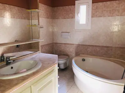 a bathroom with a tub and a sink and a toilet at Casa maria in Porto-Vecchio
