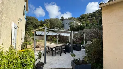 a patio with a table and a canopy at Casa maria in Porto-Vecchio