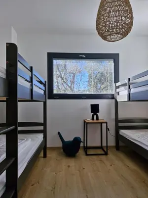 a dorm room with bunk beds and a window at NOUVEAUTE! Magnifique villa à 2 minutes des plus belles plages de la rive sud in Porticcio