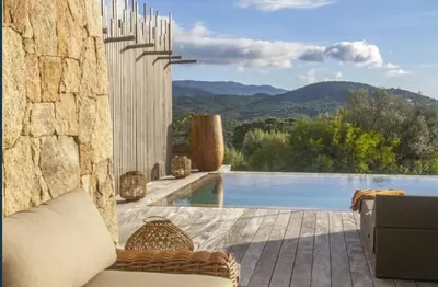 a patio with a view of a swimming pool at NOUVEAUTE! Magnifique villa à 2 minutes des plus belles plages de la rive sud in Porticcio