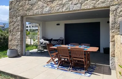 a patio with a table and chairs on a patio at Domaine d'Arca - Eluard 04 - 6 pers in Porto-Vecchio