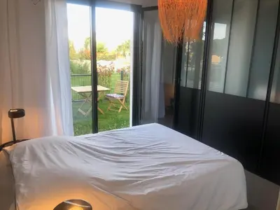 a bedroom with a bed and a view of a patio at Domaine d'Arca - Eluard 04 - 6 pers in Porto-Vecchio