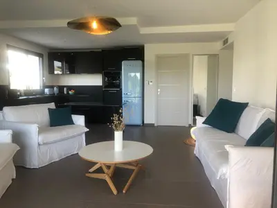 a living room with two white couches and a table at Domaine d'Arca - Eluard 04 - 6 pers in Porto-Vecchio
