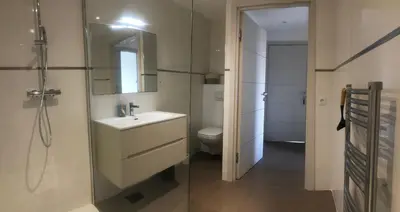 a bathroom with a sink and a toilet and a mirror at Domaine d'Arca - Eluard 04 - 6 pers in Porto-Vecchio
