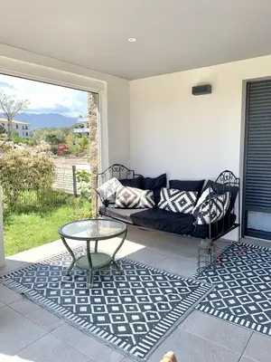 a living room with a couch and a glass table at Domaine d'Arca - Eluard 04 - 6 pers in Porto-Vecchio