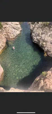 an aerial view of a body of water between rocks at Maison de village in Manso