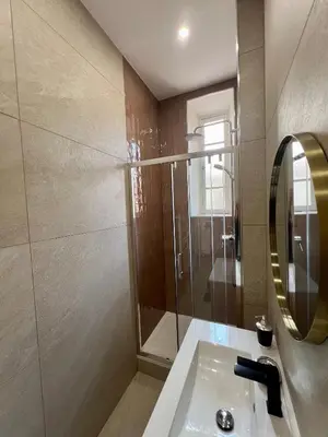 a bathroom with a shower and a sink and a mirror at Sublime T3 centre Ajaccio, équipé et climatisé in Ajaccio