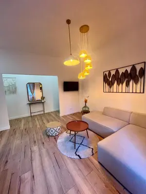 a living room with a couch and a table at Sublime T3 centre Ajaccio, équipé et climatisé in Ajaccio