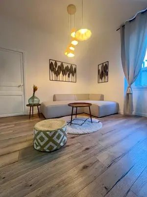 a living room with a couch and a table at Sublime T3 centre Ajaccio, équipé et climatisé in Ajaccio