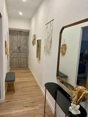 a hallway with a mirror and a door at Sublime T3 centre Ajaccio, équipé et climatisé in Ajaccio