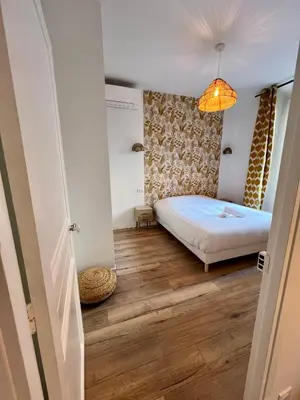 a small bedroom with a bed and a lamp at Sublime T3 centre Ajaccio, équipé et climatisé in Ajaccio