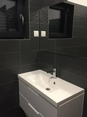 a bathroom with a white sink and a mirror at Villa Lavu Santu piscine privée vue mer/montagnes in Zonza