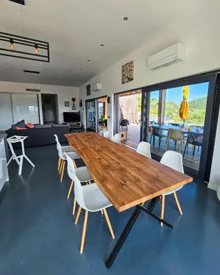 a large wooden table and chairs in a room at Villa Lavu Santu piscine privée vue mer/montagnes in Zonza