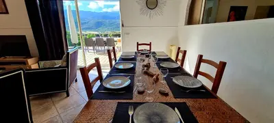 a dining room with a long table with dishes on it at Villa Bella Vista, 4ch, piscine in Figari