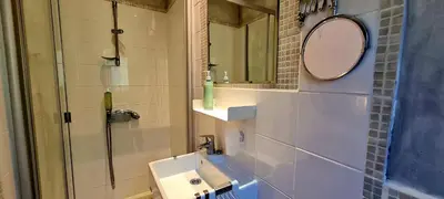 a bathroom with a sink and a mirror at Villa Bella Vista, 4ch, piscine in Figari