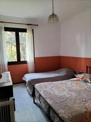 a bedroom with two beds and a window at Maison individuelle au calme in Valle-di-Mezzana