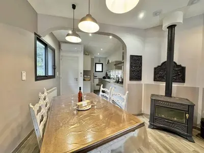a dining room with a table and a fireplace at Maison entre les montagnes à Levie in Levie