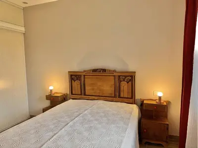 a bedroom with a large bed with two night stands at Maison entre les montagnes à Levie in Levie