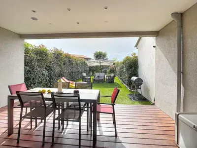 a patio with a table and chairs on a deck at Porto vecchio - St.cyprien - Corse du sud -plages in Lecci
