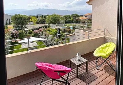 two chairs and a table on a balcony with a view at Porto vecchio - St.cyprien - Corse du sud -plages in Lecci