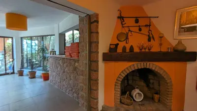 a living room with a fireplace in a house at Le Porto T3 55m2 vue mer immeuble traditionnel en pierre de taille avec prestations exceptionnelles barbecue ordinateur vidéosurveillance terrasse panoramique in Porto Ota
