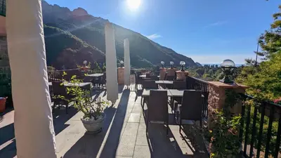 a restaurant with a view of a mountain at Le Porto T3 55m2 vue mer immeuble traditionnel en pierre de taille avec prestations exceptionnelles barbecue ordinateur vidéosurveillance terrasse panoramique in Porto Ota