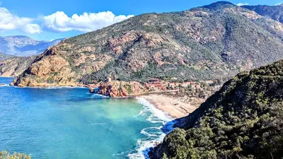 an aerial view of a beach with a mountain at Le Porto T3 55m2 vue mer immeuble traditionnel en pierre de taille avec prestations exceptionnelles barbecue ordinateur vidéosurveillance terrasse panoramique in Porto Ota