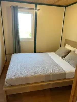 a bedroom with a canopy bed with a window at La vallee 3 in Belvédère