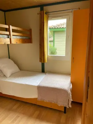 a bedroom with two bunk beds and a window at La vallee 3 in Belvédère