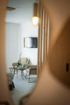 a living room with a couch and a table at La Manufacture D'oriano LES NUITS AU VILLAGE in Montegrosso