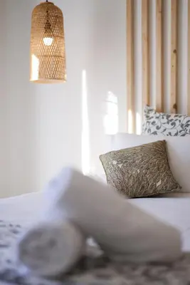 a white couch with a pillow and a lamp at La Manufacture D'oriano LES NUITS AU VILLAGE in Montegrosso