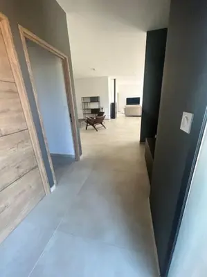 a hallway with a door and a room with a table at Villa Trinita Paradis privé piscine et loisirs in Porto-Vecchio