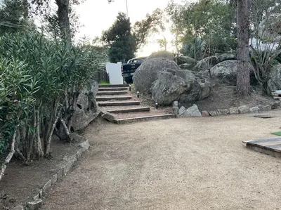 a parking lot with a bunch of rocks and stairs at A nepita di porto vecchio*** in Porto-Vecchio