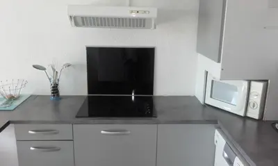 a kitchen with a microwave and a counter top at Haute Corse. Studio 4 pers .Plage Piscine. Cervione Prunete . in Cervione
