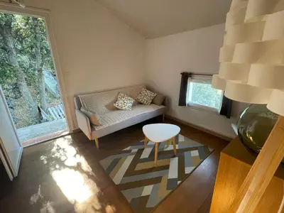 a small living room with a couch and a table at Maison de charme entre mer et montagne in Forciolo
