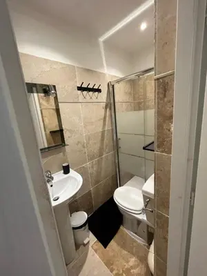 a bathroom with a toilet and a sink at Appartement douillet en ville in Ajaccio
