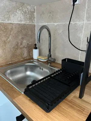 a kitchen sink with a iron grill next to it at Appartement douillet en ville in Ajaccio