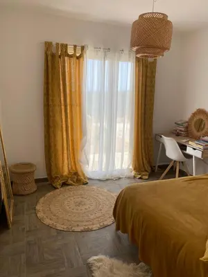 a bedroom with a bed and a desk and curtains at Villa avec piscine 3 étoiles proche plages in Monacia-dʼAullène