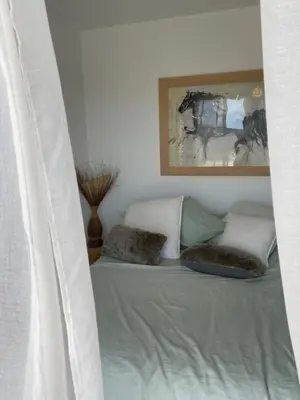 a bed with two pillows and a painting on the wall at Villa avec piscine 3 étoiles proche plages in Monacia-dʼAullène