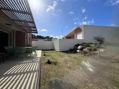 a patio with a table and chairs next to a building at Maison Joepolly corsica in Bonifacio